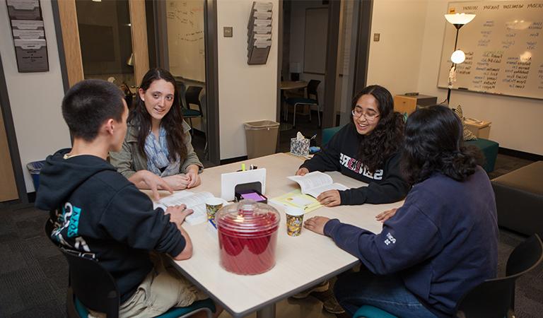 Students discussing in the Writing Center.